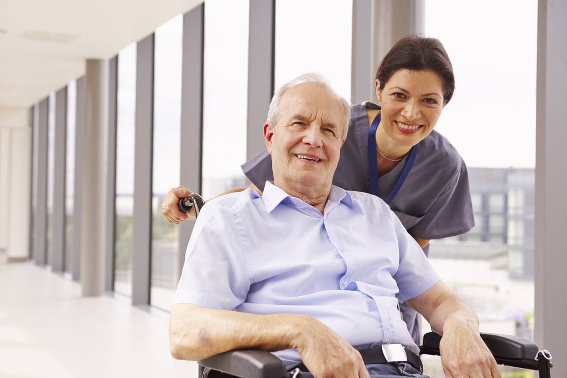 Employee - Nurse and Senior Man in Wheelchair